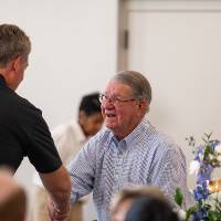 Happy Fox shaking hands with another gentleman at event